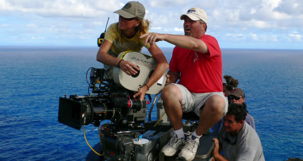 Camera Operator and AC on Dolly Above Water